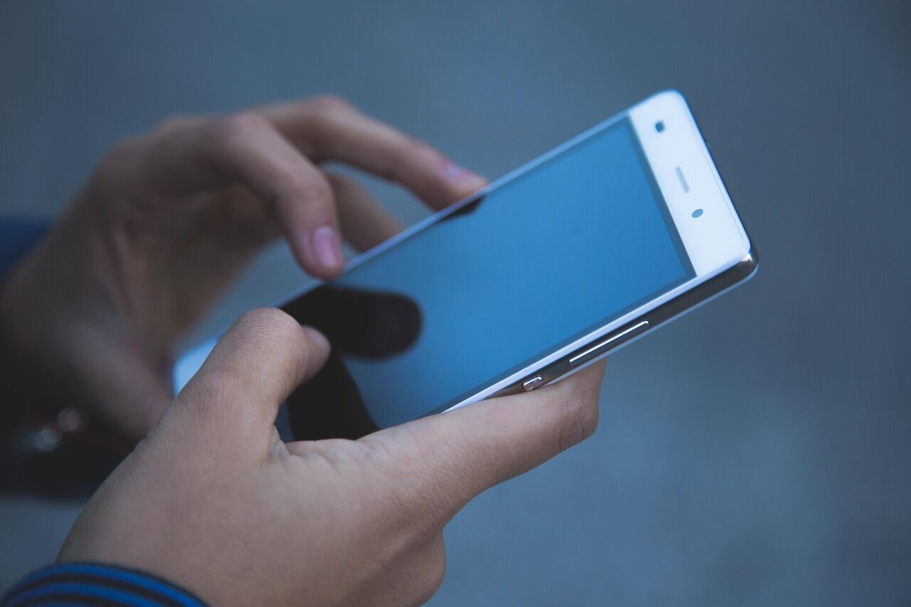Person reaching out on a smartphone