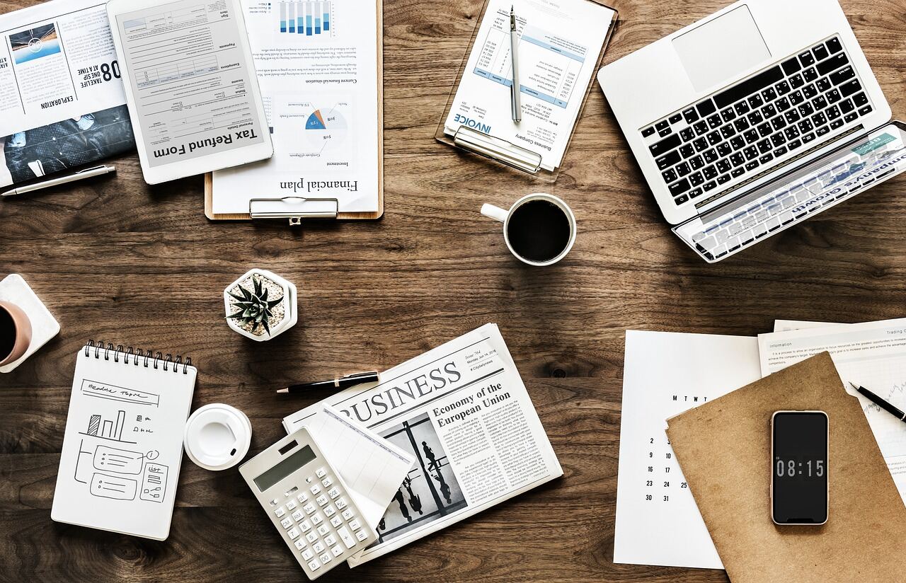 Beginner planning investments with laptop and notebook